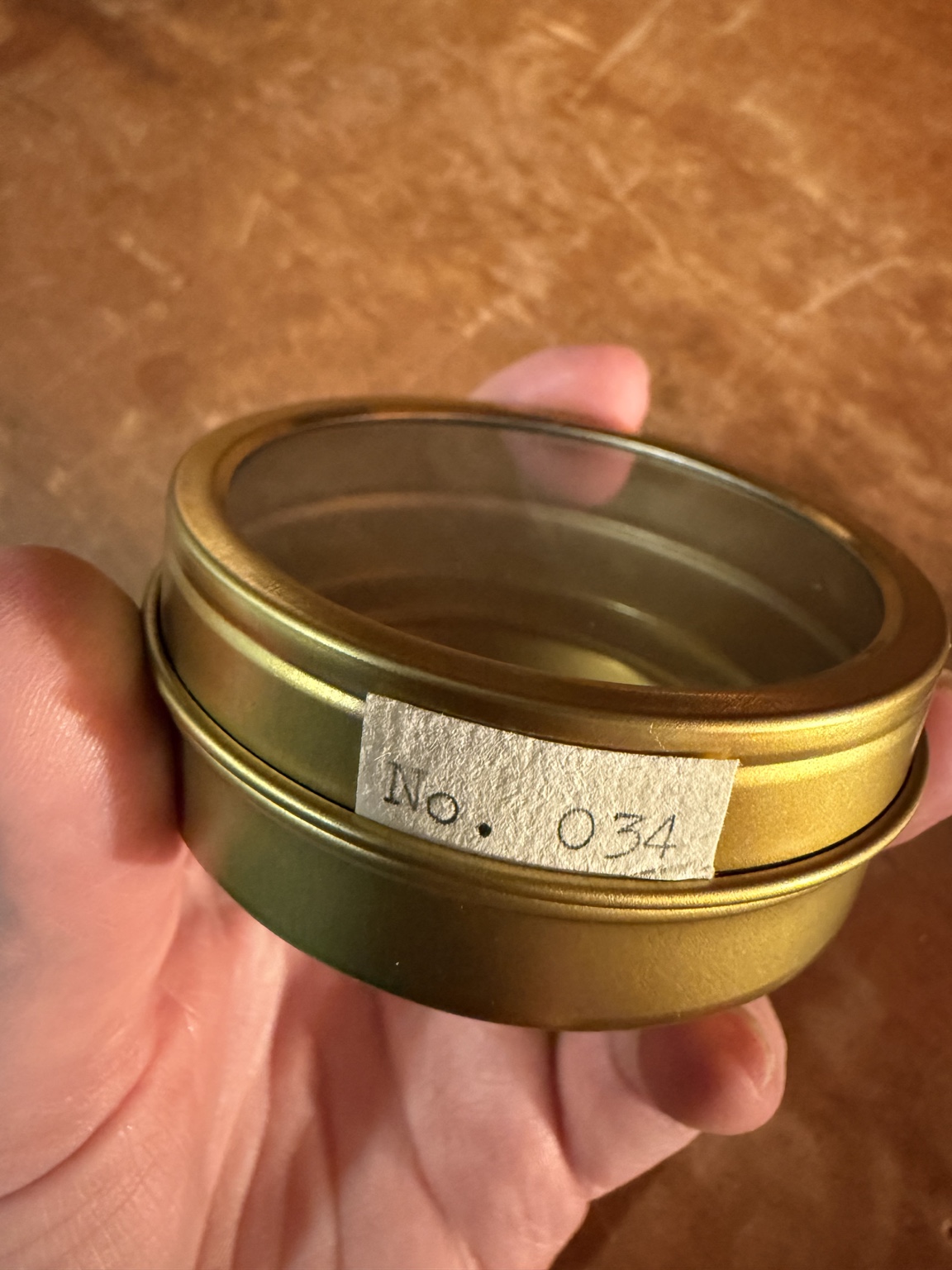 A numbered Tiny Mischief archive tin
